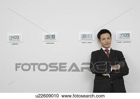 Stock Image - Businessman with time zones. Fotosearch