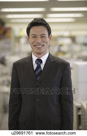 Stock Image - Man smiling for the camera, portrait. Fotosearch