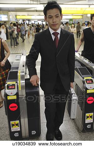 Businessman at a railroad station View Large Photo Image Stock Photo - Businessman at a railroad station. Fotosearch