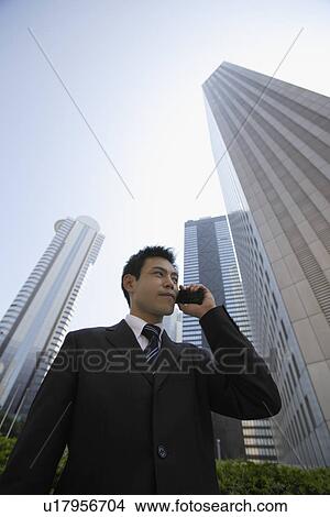 Picture - Businessman conversing on a cellphone. Fotosearch