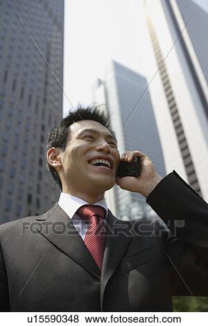 Stock Photo - Businessman conversing on a cellphone, portrait. Fotosearch