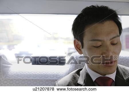Stock Photo - Businessman in car, portrait. Fotosearch
