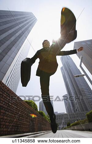 Stock Photo - Businessman jumping happily. Fotosearch