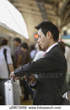 Businessman watching the time, portrait View Large Photo Image Stock Photo - Businessman watching the time, portrait. Fotosearch