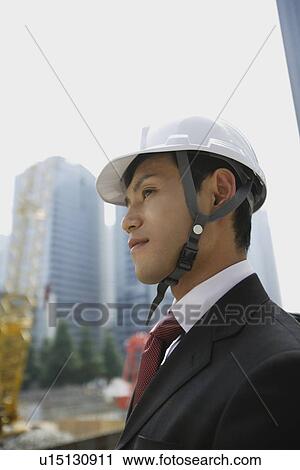 Stock Image - Businessman with a hard hat. Fotosearch