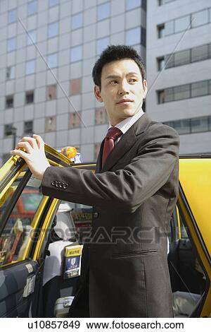 Man is stepping out of car, portrait View Large Photo Image Stock Photo - Man is stepping out of car, portrait. Fotosearch