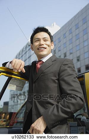 Man leaning against car door, portrait View Large Photo Image Stock Image - Man leaning against car door, portrait. Fotosearch