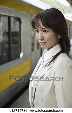 Businesswoman at a railroad station View Large Photo Image Stock Image - Businesswoman at a railroad station. Fotosearch
