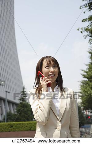 Businesswoman conversing on a cellphone, portrait View Large Photo Image Picture - Businesswoman conversing on a cellphone, portrait. Fotosearch