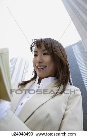 Businesswoman reading a book, portrait View Large Photo Image Stock Photo - Businesswoman reading a book, portrait. Fotosearch