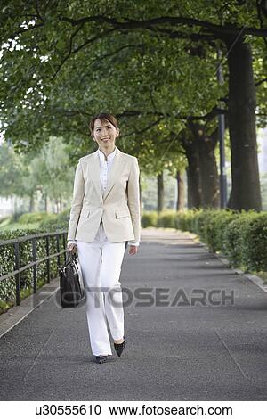 Stock Image - View of a professional woman with a handbag. Fotosearch