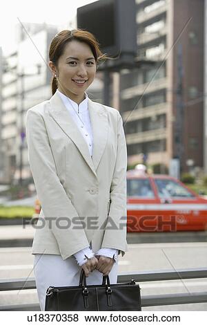Stock Photo - View of a professional woman with a handbag. Fotosearch