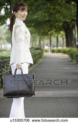 Stock Photograph - View of a professional woman with a handbag. Fotosearch
