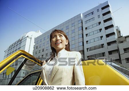 Stock Image - Woman near a car, portrait. Fotosearch