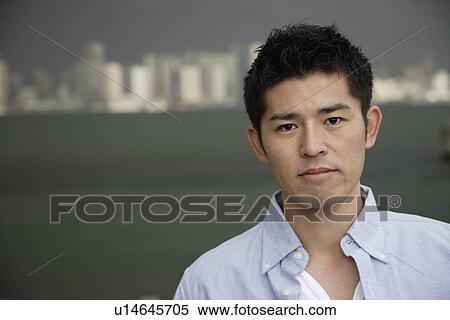 Portrait of a serious young man View Large Photo Image Stock Photography - Portrait of a serious young man. Fotosearch