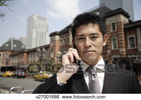 Portrait of a young businessman using a mobile phone View Large Photo Image Stock Photo - Portrait of a young businessman using a mobile phone. Fotosearch