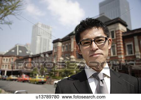 Portrait of a young businessman wearing glasses View Large Photo Image Stock Image - Portrait of a young businessman wearing glasses. Fotosearch