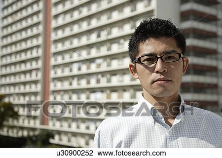 Stock Image - Portrait of a young man wearing glasses. Fotosearch