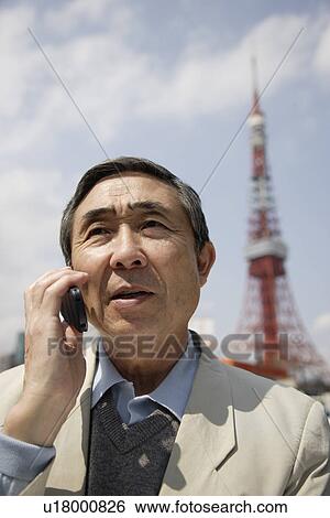 Stock Photograph - A senior man using mobile phone. Fotosearch