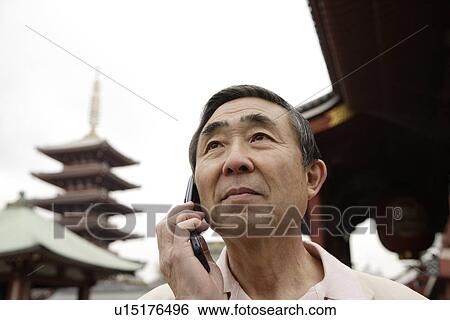 Close-up of a senior man using mobile phone View Large Photo Image Stock Photograph - Close-up of a senior man using mobile phone. Fotosearch