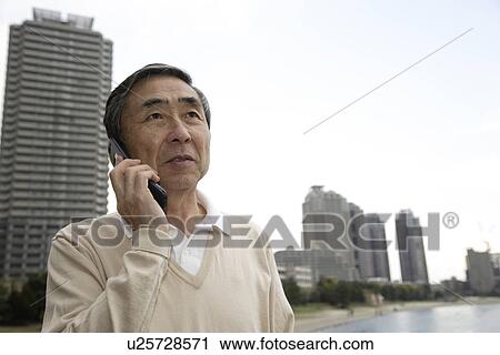 View of a senior man using mobile phone View Large Photo Image Stock Image - View of a senior man using mobile phone. Fotosearch