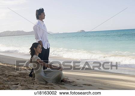 Stock Image - A young couple at beach. Fotosearch