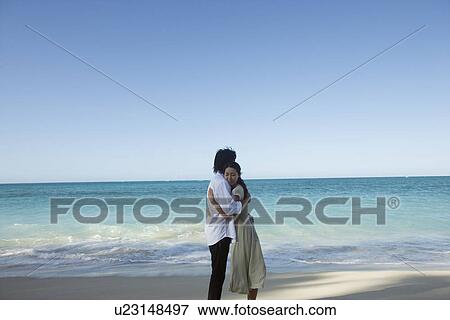 A young couple hugging each other at beach View Large Photo Image Stock Photo - A young couple hugging each other at beach. Fotosearch