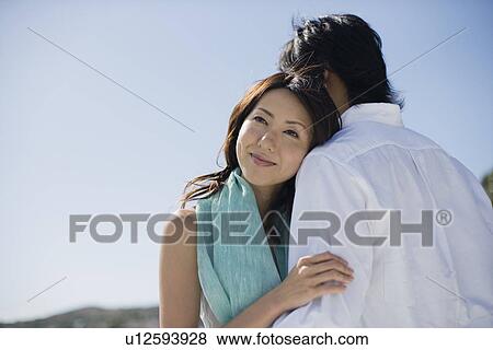 A young couple hugging each other View Large Photo Image Stock Photo - A young couple hugging each other. Fotosearch