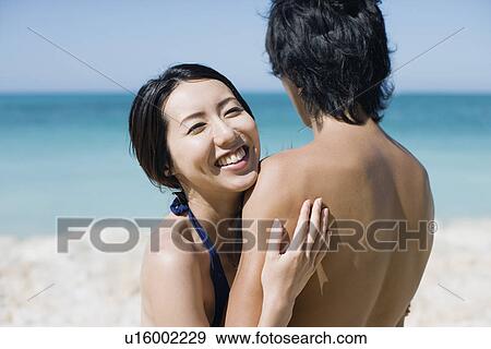 A young couple hugging each other View Large Photo Image Stock Photo - A young couple hugging each other. Fotosearch