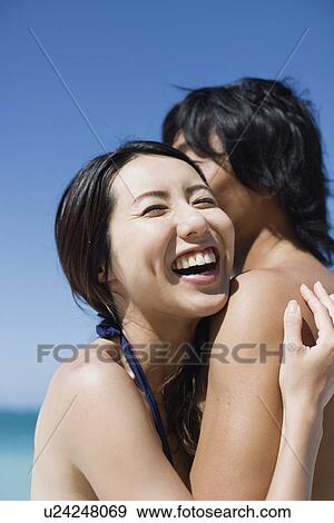 A young couple hugging each other View Large Photo Image Stock Photo - A young couple hugging each other. Fotosearch
