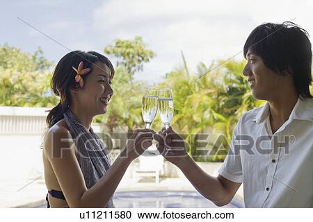 Profile of a young couple toasting wineglass View Large Photo Image Stock Image - Profile of a young couple toasting wineglass. Fotosearch