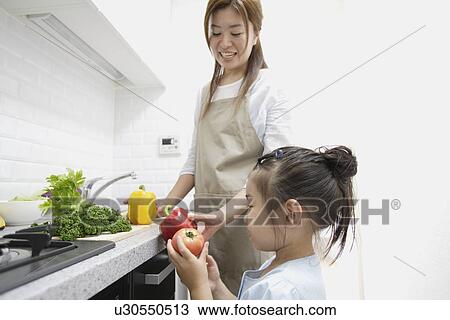 A mother and daughter in a kitchen View Large Photo Image Stock Image - A mother and daughter in a kitchen. Fotosearch