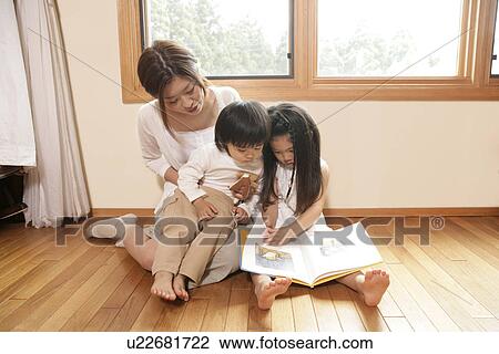 A mother telling stories to her children from a story book View Large Photo Image Stock Image - A mother telling stories to her children from a story book. Fotosearch