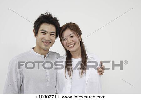 A young couple standing side-by-side View Large Photo Image Stock Image - A young couple standing side-by-side. Fotosearch
