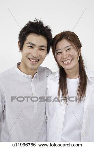 A young couple standing side-by-side View Large Photo Image Stock Photograph - A young couple standing side-by-side. Fotosearch