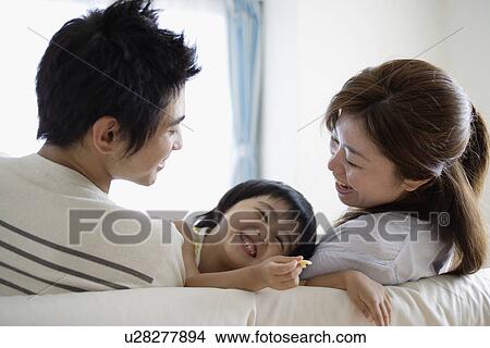 Picture - A young couple with a child. Fotosearch