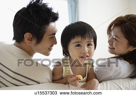 A young couple with a child View Large Photo Image Stock Image - A young couple with a child. Fotosearch