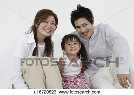 Stock Image - A young couple with a girl. Fotosearch