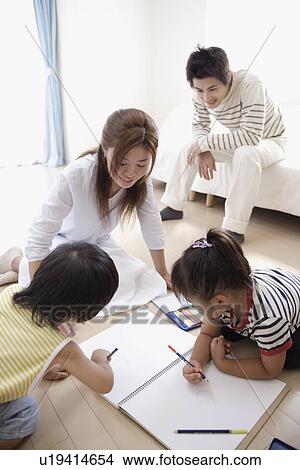 Picture - A young couple with two children. Fotosearch