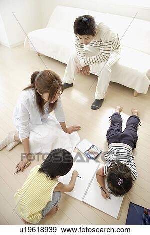 Stock Photo - A young couple with two children. Fotosearch