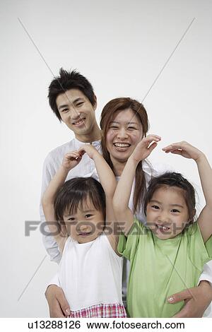 A young couple with two girls View Large Photo Image Stock Photograph - A young couple with two girls. Fotosearch