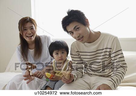 A young family sitting in a group View Large Photo Image Stock Image - A young family sitting in a group. Fotosearch