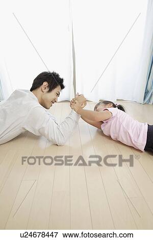A young father playing with his daughter View Large Photo Image Stock Photo - A young father playing with his daughter. Fotosearch