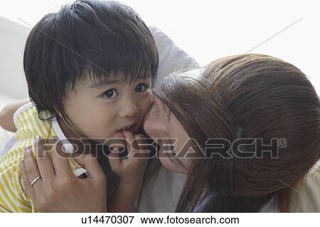A young mother with a child View Large Photo Image Stock Photo - A young mother with a child. Fotosearch