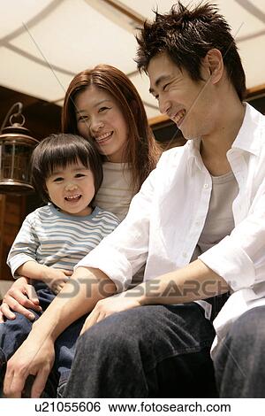 Stock Photograph - Happy moment of a family captured in the camera. Fotosearch