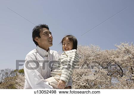 Stock Photo - Father carrying daughter. Fotosearch