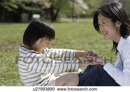 Mother and daughter playing in garden View Large Photo Image Stock Image - Mother and daughter playing in garden. Fotosearch