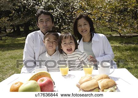 Portrait of a family having breakfast View Large Photo Image Picture - Portrait of a family having breakfast. Fotosearch