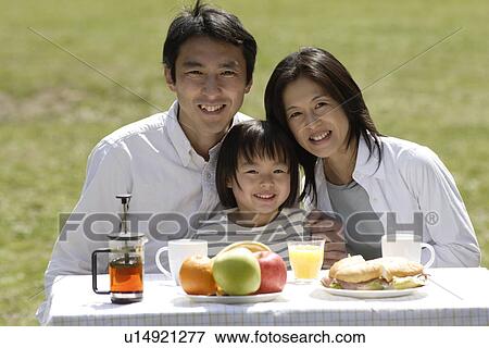 Stock Photo - Portrait of a family having breakfast. Fotosearch
