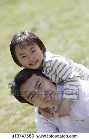 Portrait of a father carrying daughter on back View Large Photo Image Stock Image - Portrait of a father carrying daughter on back. Fotosearch